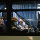 The U.S. reported its first death from coronavirus on Saturday. In this photo, American citizens look out the window as they’re evacuated from the quarantined Diamond Princess cruise ship.